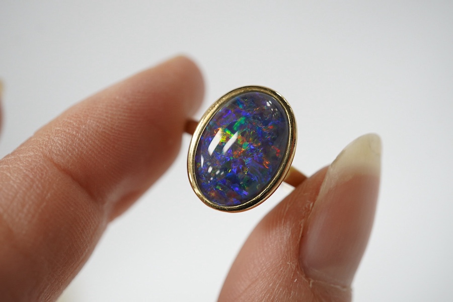 A modern 9ct gold and oval opal triplet set ring, size P/Q, gross weight 4 grams. Condition - good